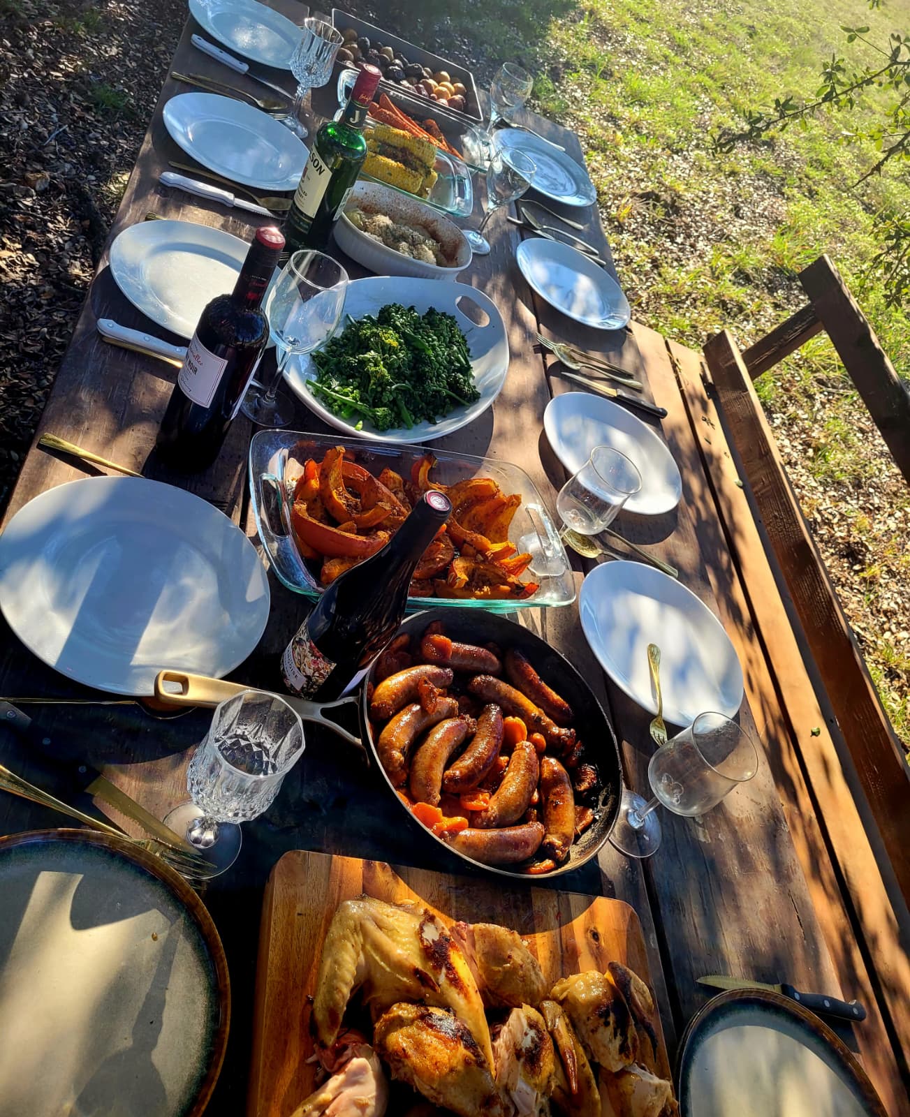 Overhead view of a shared feast with wine on a wooden table