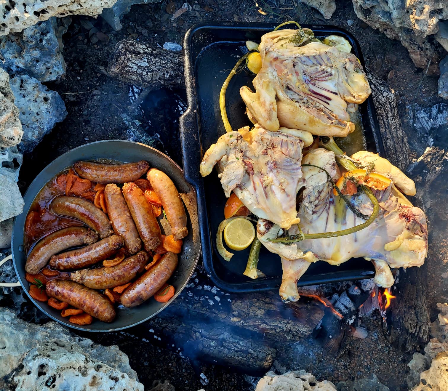 Chicken and sausages cooking over an open fire